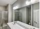 Ensuite bathroom with dual sinks, vanity, tiled shower, and modern fixtures at 656 Barneswyck Dr, Fuquay Varina, NC 27526
