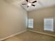 Spacious bedroom with plush carpeting, ample natural light, and a ceiling fan at 656 Barneswyck Dr, Fuquay Varina, NC 27526