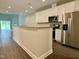 Modern kitchen with white cabinetry, granite countertops, and stainless steel appliances at 656 Barneswyck Dr, Fuquay Varina, NC 27526