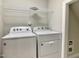Well-lit laundry room featuring a new white washer and dryer with overhead storage shelf at 656 Barneswyck Dr, Fuquay Varina, NC 27526