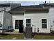 View of the home's rear exterior with a patio, sliding glass doors, and an air conditioning unit at 656 Barneswyck Dr, Fuquay Varina, NC 27526