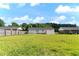 Large backyard with grass and a white storage shed near neighboring houses at 729 Carolina Dr, Dunn, NC 28334