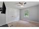 This bedroom has neutral walls, ceiling fan, window and large closet at 729 Carolina Dr, Dunn, NC 28334