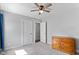 Inviting bedroom with carpet, ceiling fan, closet, dresser, and trim molding at 729 Carolina Dr, Dunn, NC 28334