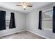 This is a bedroom with windows, neutral walls, ceiling fan, and carpet at 729 Carolina Dr, Dunn, NC 28334
