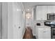 Bright hallway featuring hardwood floors and white cabinetry in kitchen view at 729 Carolina Dr, Dunn, NC 28334