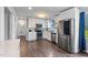 Modern eat-in kitchen features stainless steel appliances, wooden flooring, and updated lighting at 729 Carolina Dr, Dunn, NC 28334