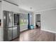 Bright kitchenette with stainless steel refrigerator and lots of natural light at 729 Carolina Dr, Dunn, NC 28334