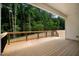 Covered back porch overlooking a private, wooded backyard at 80 Birchtop Cir, Zebulon, NC 27597