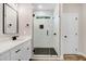 Modern bathroom features a glass shower with black fixtures, white cabinets, and quartz countertops at 80 Birchtop Cir, Zebulon, NC 27597