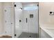 Bathroom featuring a glass-enclosed shower with gray tiled flooring and walls at 80 Birchtop Cir, Zebulon, NC 27597