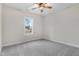 Bedroom with neutral paint, plush carpet, a ceiling fan, and a window providing ample natural light at 80 Birchtop Cir, Zebulon, NC 27597