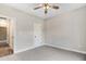 Comfortable bedroom with a ceiling fan, carpet, neutral paint, and a door leading to other rooms at 80 Birchtop Cir, Zebulon, NC 27597