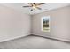 Cozy bedroom features a ceiling fan, a window, carpet, and neutral paint, creating a serene atmosphere at 80 Birchtop Cir, Zebulon, NC 27597