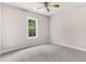 Bright bedroom with a ceiling fan, carpet, neutral paint, and a window overlooking the outdoors at 80 Birchtop Cir, Zebulon, NC 27597