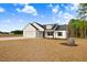 Charming single-story home with white siding, black accents, and an attached two-car garage at 80 Birchtop Cir, Zebulon, NC 27597