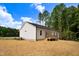 Exterior side view of a modern white house, with a new wooden porch at 80 Birchtop Cir, Zebulon, NC 27597