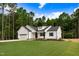 Beautiful new construction home with a two-car garage and manicured lawn in a wooded setting at 80 Birchtop Cir, Zebulon, NC 27597