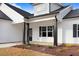 Close-up view of a charming front porch with black columns and dark-framed windows at 80 Birchtop Cir, Zebulon, NC 27597