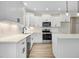 Bright kitchen featuring white cabinetry, stainless steel appliances, and stylish black hardware accents at 80 Birchtop Cir, Zebulon, NC 27597
