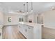 This open-concept kitchen boasts an eat-in island, plenty of prep space, and a clear view of the living room fireplace at 80 Birchtop Cir, Zebulon, NC 27597