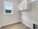 Laundry room boasts natural light, white cabinets, and room for laundry appliances at 80 Birchtop Cir, Zebulon, NC 27597