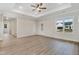 Spacious living room showcasing tray ceilings, wood flooring, and lots of natural light at 80 Birchtop Cir, Zebulon, NC 27597