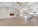 Open-concept living room with modern fireplace, wood floors, and seamless access to the kitchen at 80 Birchtop Cir, Zebulon, NC 27597