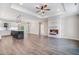 Spacious living room with wood floors, tray ceilings, and fireplace feature flows into the kitchen at 80 Birchtop Cir, Zebulon, NC 27597