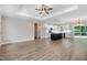 Open-concept living room with wood floors, tray ceilings, and a view of the kitchen at 80 Birchtop Cir, Zebulon, NC 27597