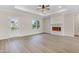 Inviting living room with tray ceilings, wood-look floors, fireplace and plenty of natural light at 80 Birchtop Cir, Zebulon, NC 27597