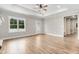 Bright living room with wood floors, tray ceilings, and view of the front yard through a large window at 80 Birchtop Cir, Zebulon, NC 27597