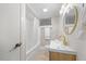 Bright bathroom with a shower-tub combo, vanity with modern fixtures, and neutral finishes at 800 Camden Ave, Durham, NC 27701