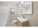 Modern bathroom with tub and shower combination, vanity with sink, complemented by natural light at 800 Camden Ave, Durham, NC 27701
