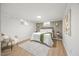 Cozy bedroom with accent wall, hardwood floors, large windows, and minimalist decor at 800 Camden Ave, Durham, NC 27701