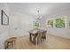 Bright dining room featuring hardwood floors, modern chandelier, and ample natural light at 800 Camden Ave, Durham, NC 27701