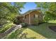 Beautiful single-story home featuring mature trees, brick facade, and a well-manicured lawn at 800 Camden Ave, Durham, NC 27701