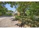 View of a cozy home with lush front yard landscaping and a long, paved driveway at 800 Camden Ave, Durham, NC 27701