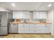 Well-lit kitchen features stainless steel appliances, white cabinets and butcher block countertops at 800 Camden Ave, Durham, NC 27701
