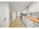 Basement kitchen featuring modern appliances, bright cabinetry and a view of the stairwell at 800 Camden Ave, Durham, NC 27701