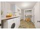 Bright laundry room with front load washer and dryer, cabinets and storage at 800 Camden Ave, Durham, NC 27701