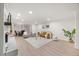 Open living room and dining area with a brick fireplace, modern furniture and hardwood floors at 800 Camden Ave, Durham, NC 27701