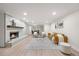 Open living room and dining area with a brick fireplace, modern furniture and hardwood floors at 800 Camden Ave, Durham, NC 27701