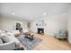 Inviting living room featuring a cozy fireplace, hardwood floors, and plenty of natural light at 800 Camden Ave, Durham, NC 27701