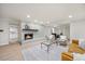Open living room and dining area with a brick fireplace, modern furniture and hardwood floors at 800 Camden Ave, Durham, NC 27701