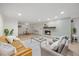 Open living room and dining area with a brick fireplace, modern furniture and hardwood floors at 800 Camden Ave, Durham, NC 27701