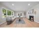 Inviting living room with hardwood floors, fireplace, and large windows, providing ample natural light at 800 Camden Ave, Durham, NC 27701