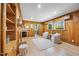 Spacious living room with hardwood floors, wood paneling, and bright windows overlooking the yard at 800 Camden Ave, Durham, NC 27701
