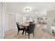 Open-concept living room with a poker table, light wood floors, and stylish decor throughout at 800 Camden Ave, Durham, NC 27701