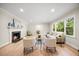 Warm living room with hardwood floors, fireplace, and large windows, ideal for relaxing and entertaining at 800 Camden Ave, Durham, NC 27701
